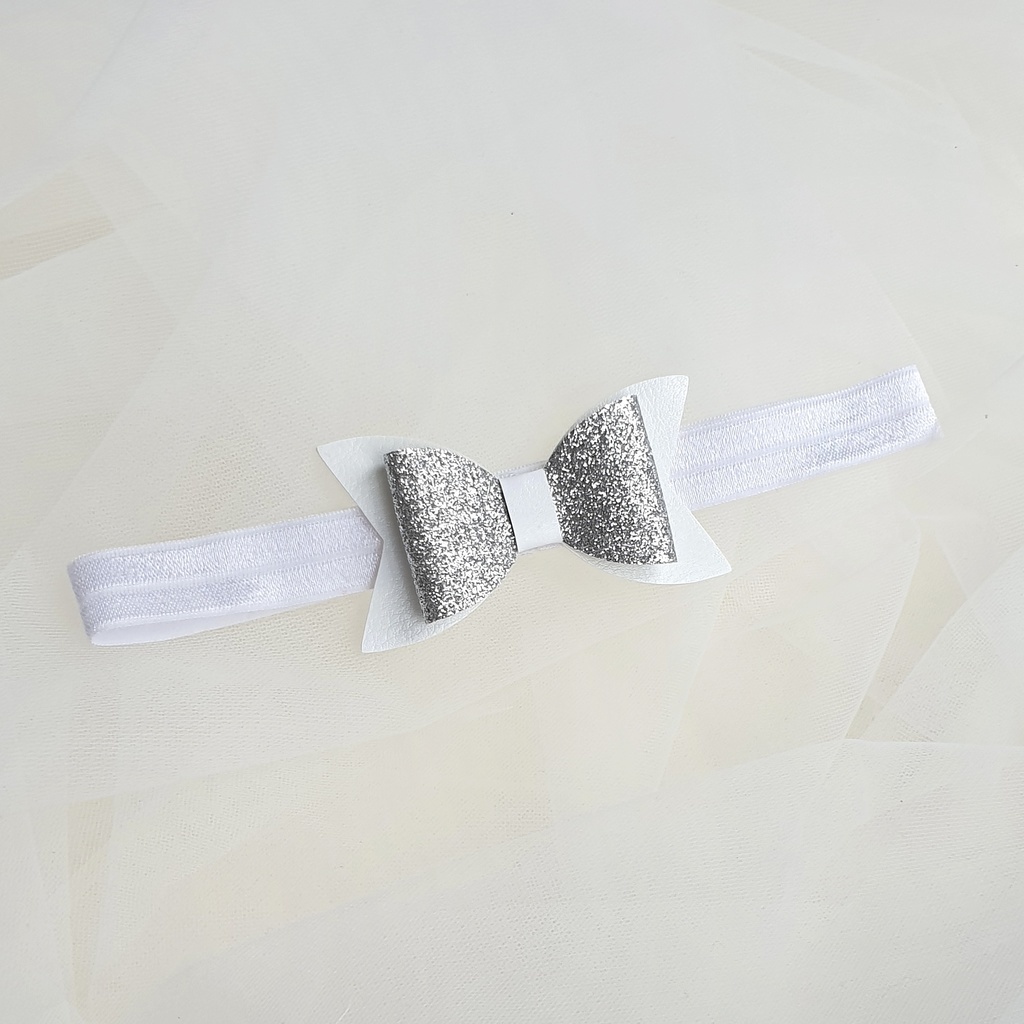 Повязка на голову "Блестящий бант" серебряный на белой резинке