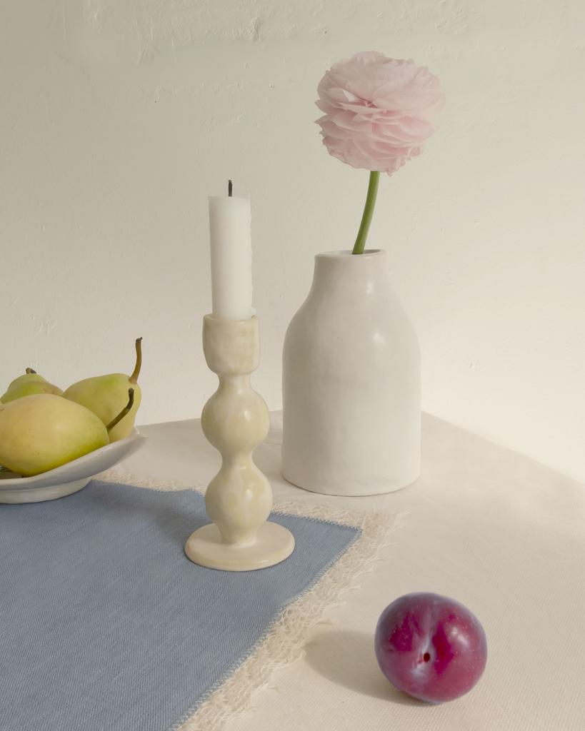Белая керамическая ваза в сервировке стола