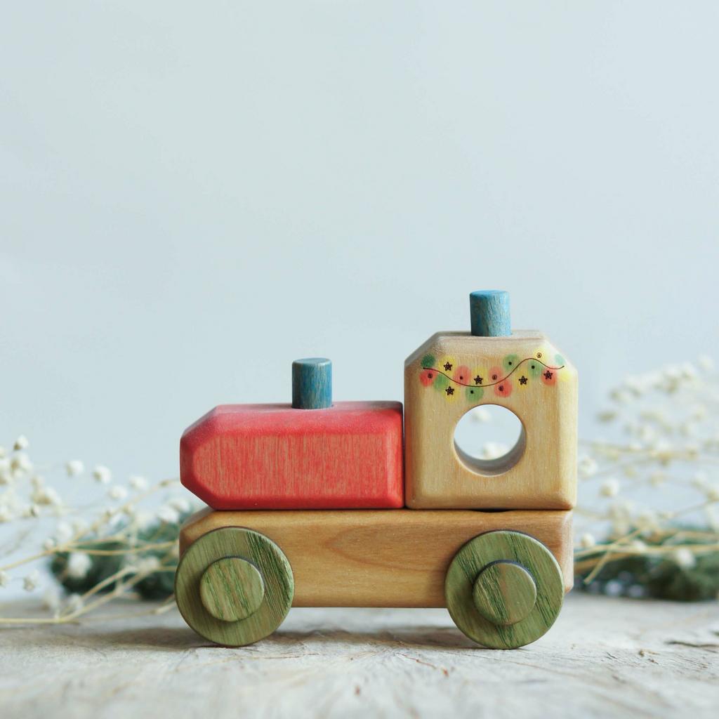 Locomotive wooden toy with a garland