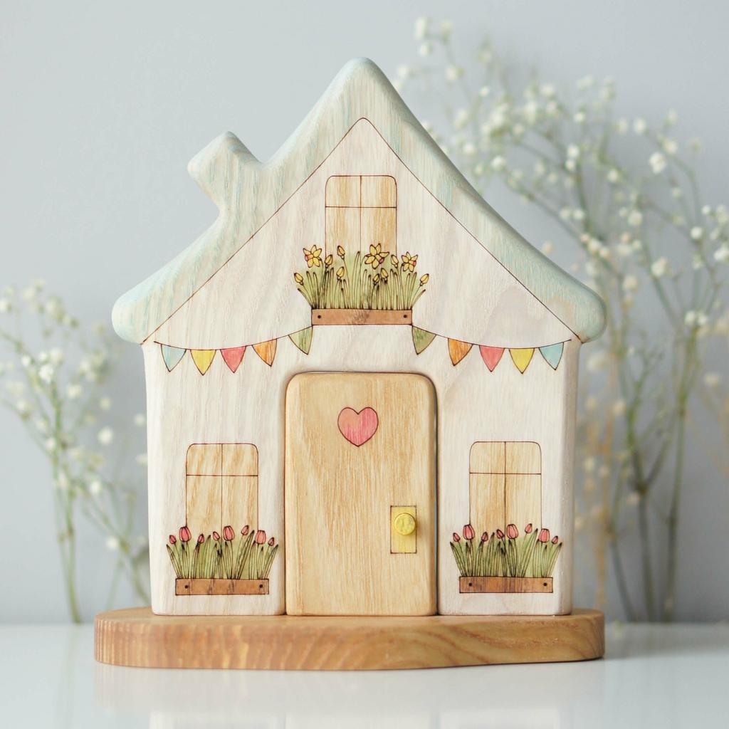 White house with blue roof wooden toy