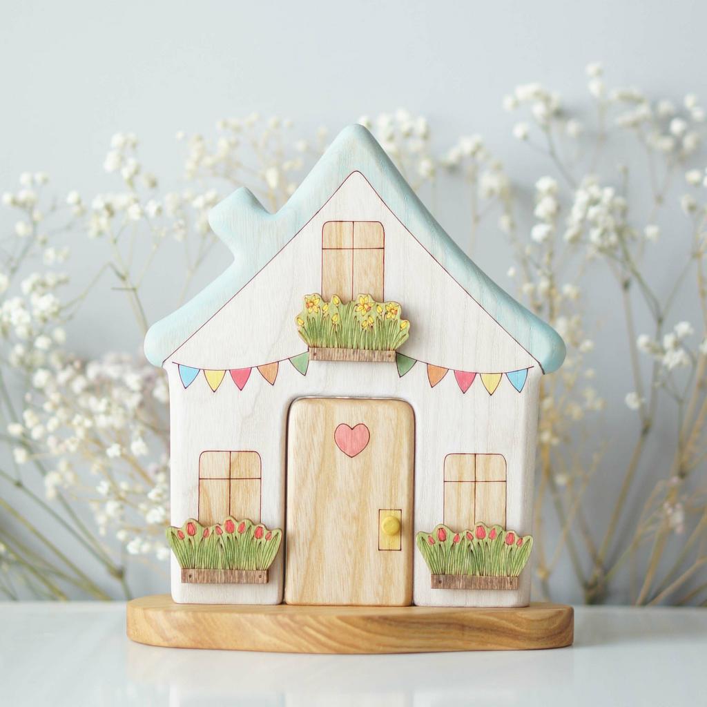 White house with blue roof wooden toy