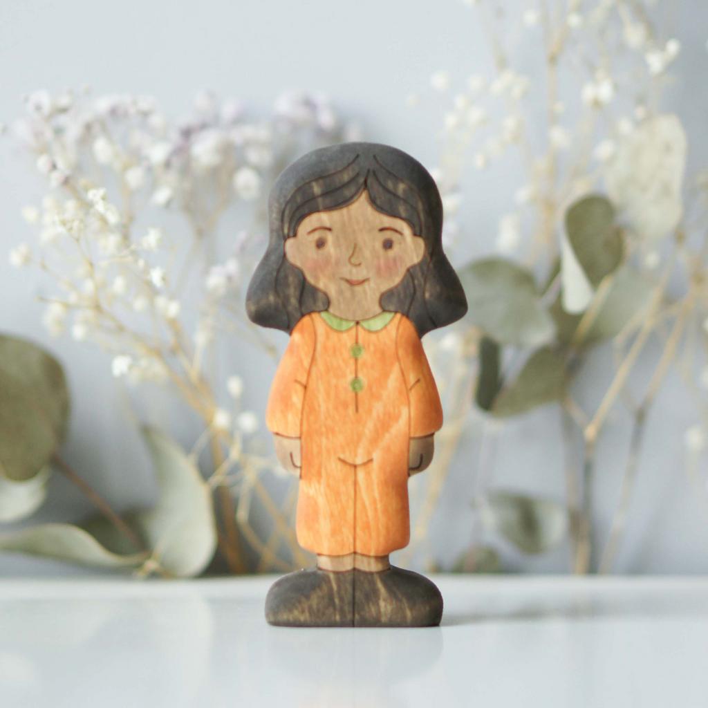 Girl (in orange) brunette (dark skin)