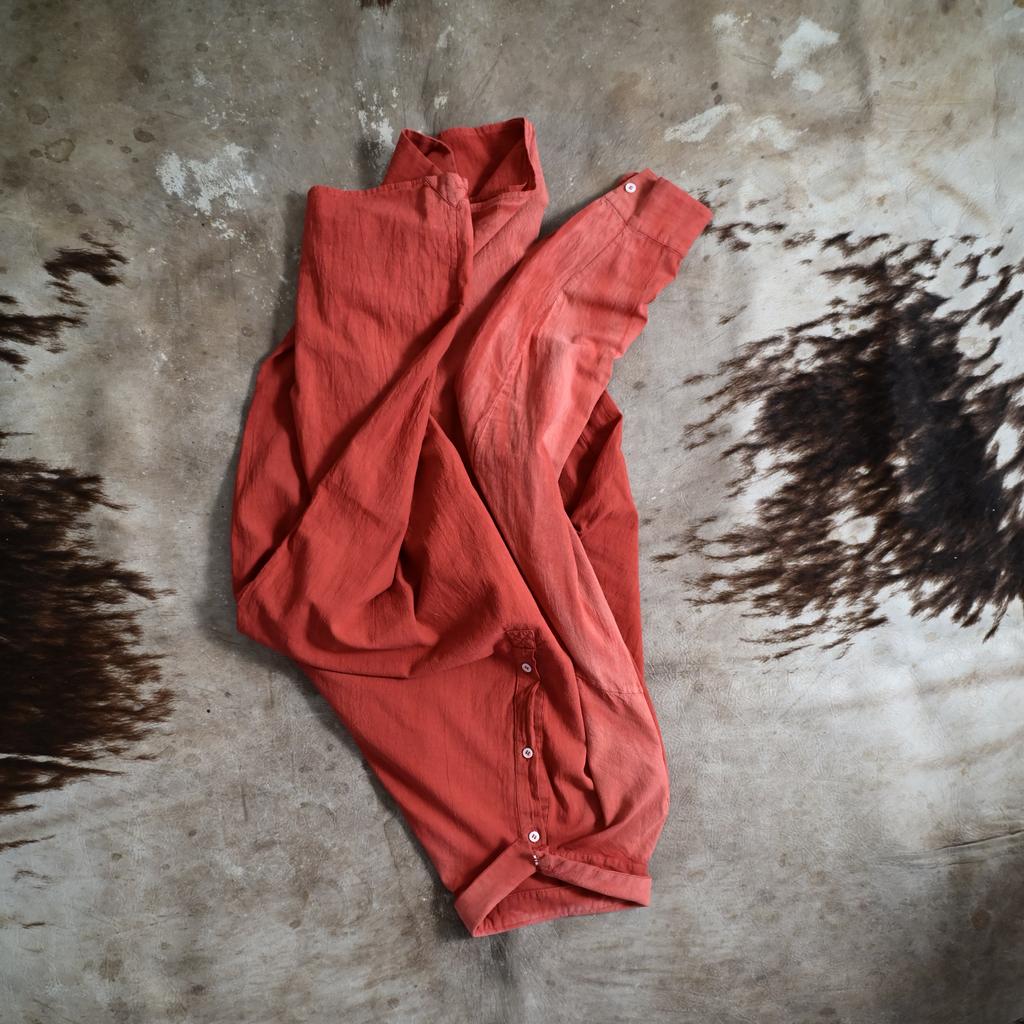 Volkh's sun-faded blood-red shirt