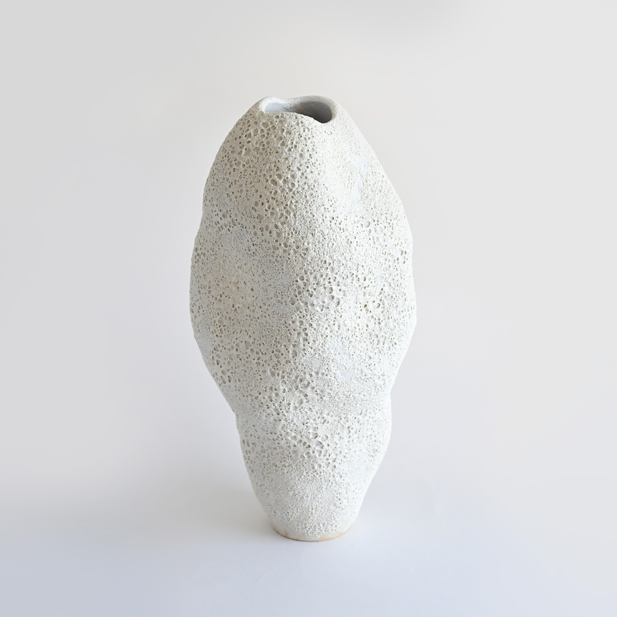White  handmade ceramic vase rustic/boho style with a foamy, lava-like surface