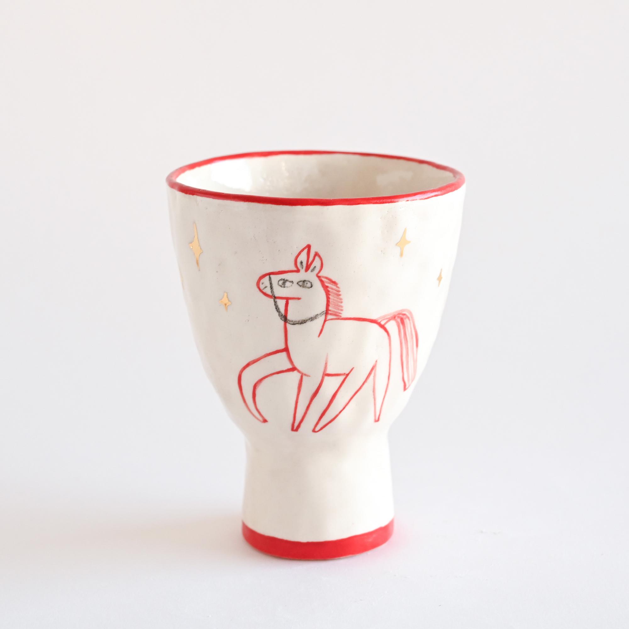 Handmade ceramic cup with a hand-painted horse illustration