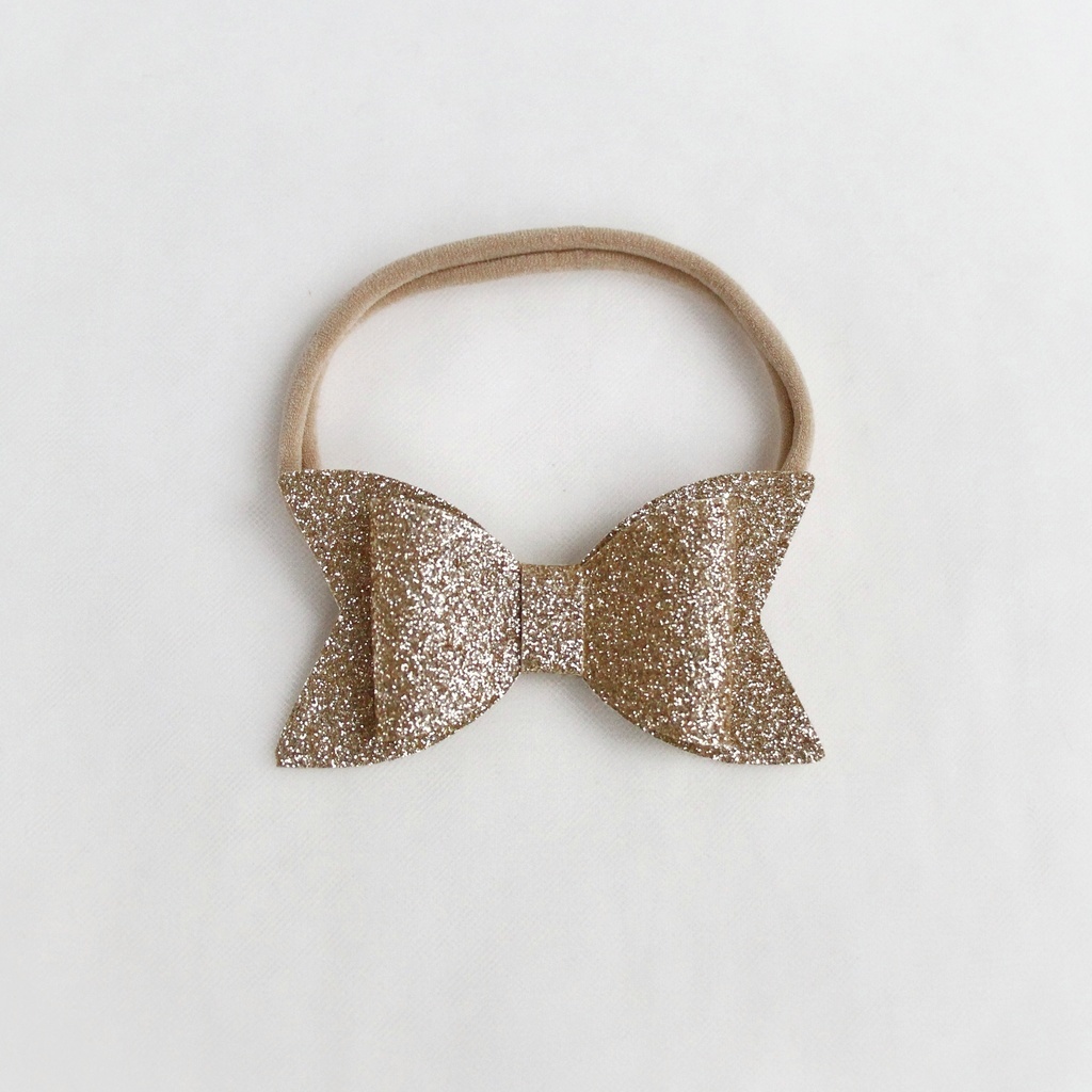 Повязка на голову "Блестящий бант" золотой