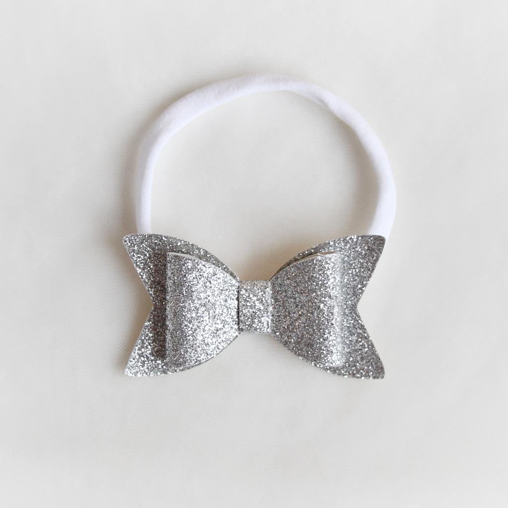 Повязка на голову "Блестящий бант" серебряный