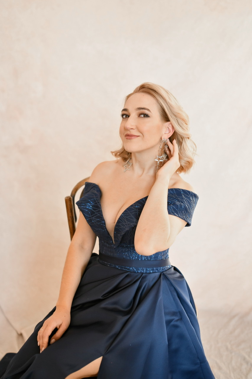 Синее атласное платье со спущенными плечами и расшитым верхом