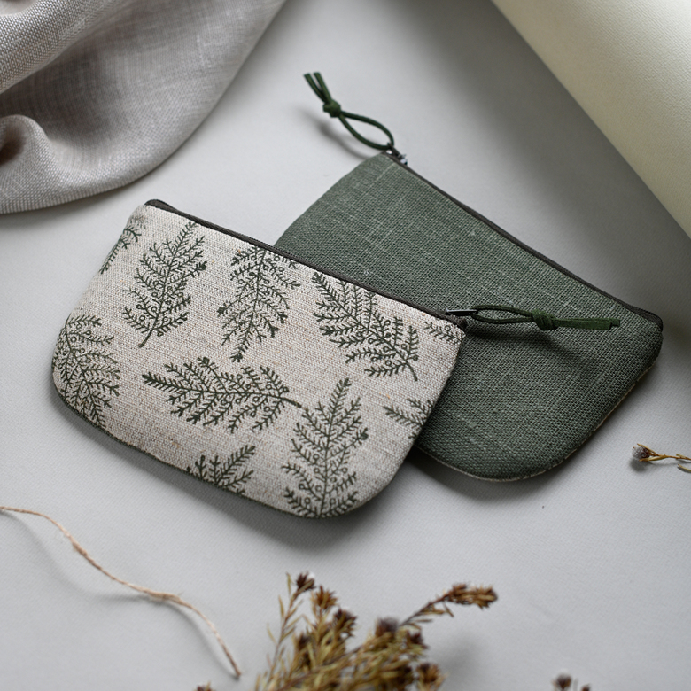 Coin pouch with small pine tre branches.